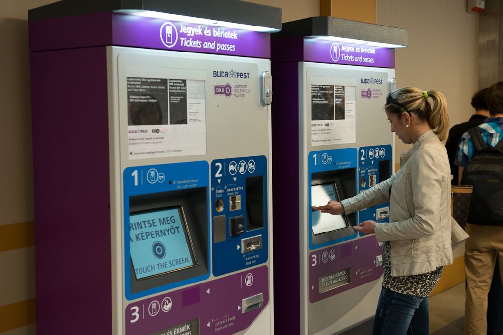 woman using ticket machine in metro